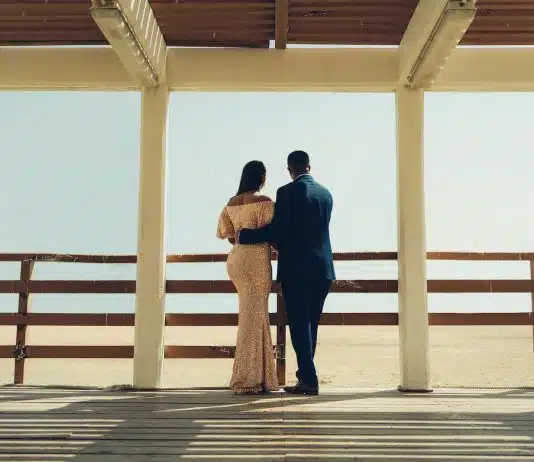 man and woman standing on wooden dock during daytime